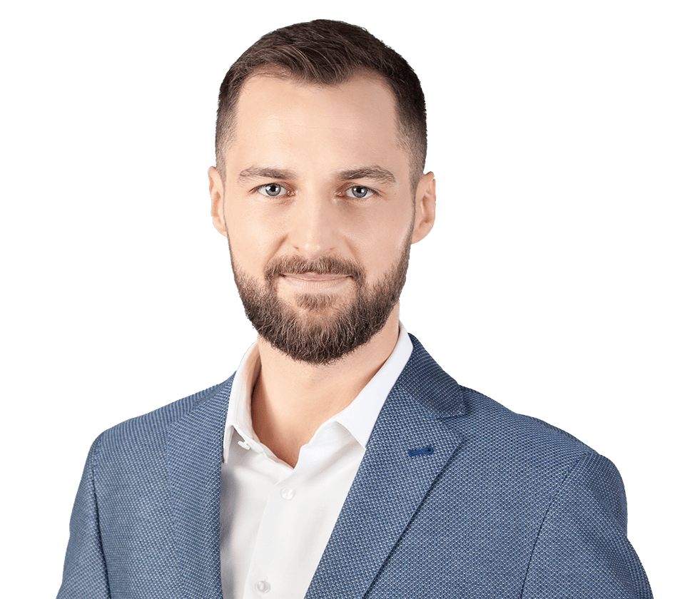 Cyprian Kowalczyk - Founder and CEO @ iRonin.IT. A person wearing a blue textured blazer over a white dress shirt. The background is plain white.